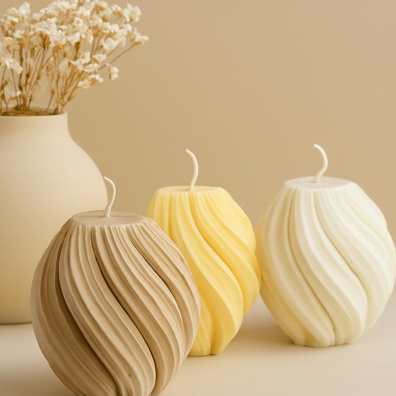 Three twisted soy wax candles in cream, yellow and beige